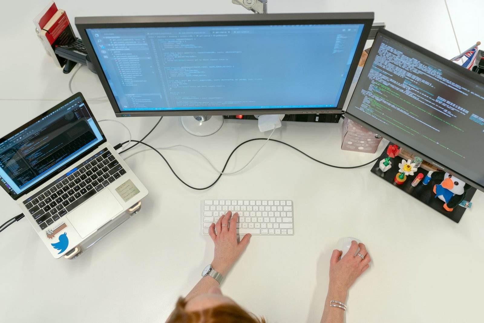 Data analyst building Power BI dashboards on dual monitors